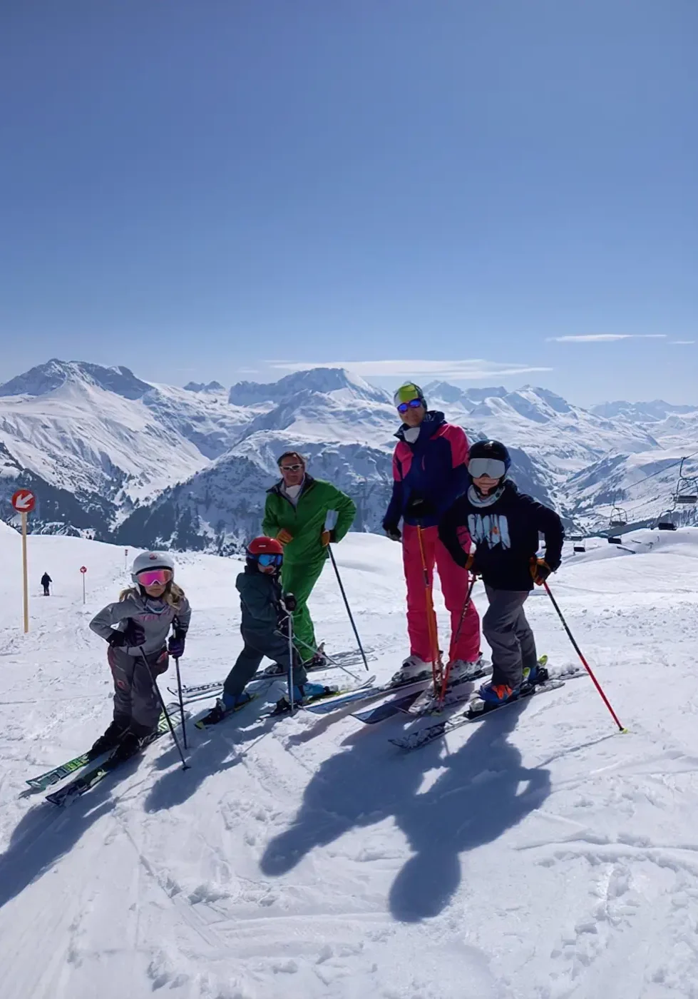 Beautiful family during a skiing day in the Arlberg on a sunny day